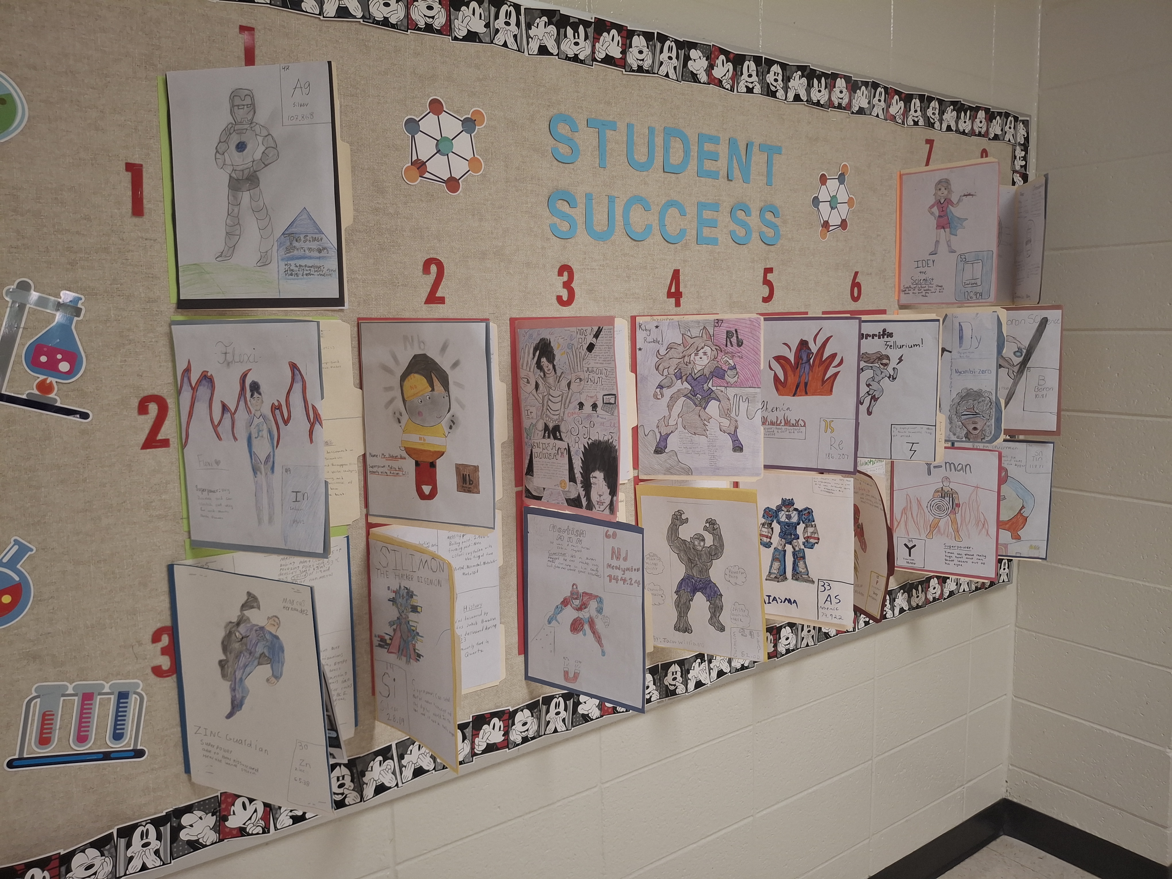 Hallway display of 18 student element projects